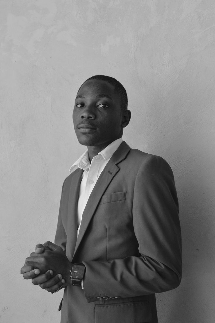 services-img Grayscale portrait of a confident man in a suit. Perfect for business or professional themes.